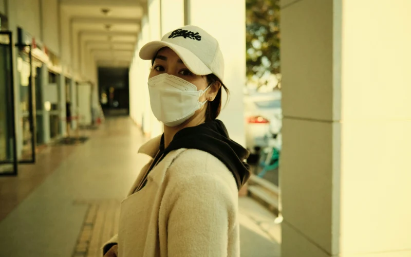 Person wearing N95 mask outdoors during wildfire smoke event