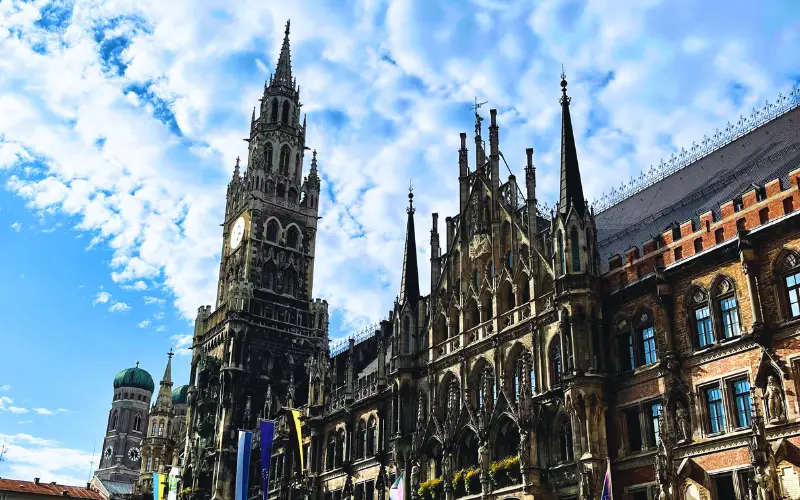 View of Munich’s historic city center with gothic architecture under a bright sky, representing Germany’s blend of cultural heritage and modern sustainability efforts.